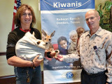 Kiwanian Bill Wright presents the “You Make A Difference” award to Scott Edwards who is holding Joey.