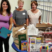 Members of the Wisconsin Club and After Schoolers Club donate bags of school supplies to Borman Elementary School.
