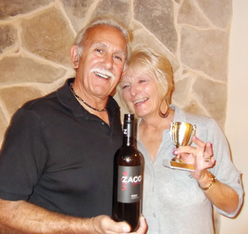 Wayne and Pam Casalino show off their winning wine and the traveling trophy for Tuesday Tasters.