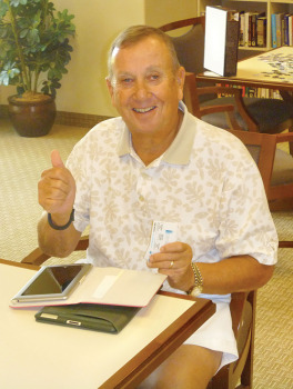 George Bowdouris gives the thumbs up signal after successfully connecting both an iPad and a Kindle Fire.