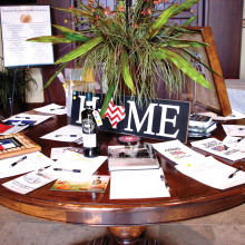 Table with Americana items immediately inside the clubhouse entrance.