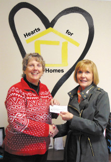 Hearts for Homes director Susan Frank receives check from Mala Bowdouris.
