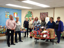 After Schoolers Club with Principal Robert Gonzales after sorting donated food for Christmas baskets.