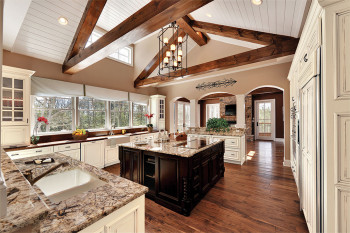 Traditional: The architectural and top-to-bottom details are crucial to the design of this kitchen. From the beams and archways to the mullion cabinet doors and island legs, this kitchen portrays every aspect of traditional.