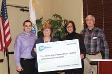 Representatives from CoServ Craig Chambers, Ann Reagan and Richard Muir present a check to Kiwanis President, Carol Rauhauser.