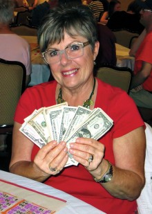 Maureen Lehrer is proudly displaying her winnings. Photo by Vicki Baker