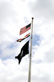 WWII flag and banner over the Veterans Park during the ceremony