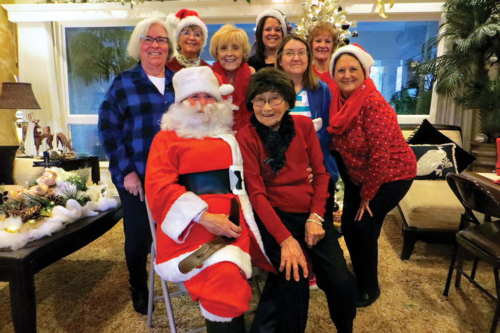Santa and the Dames spreading joy at the Ranch, front row: Santa (Vicki Baker) and Alice Uyeda; second row: Donna French, Glenda Carr, Susan Volgamore and Linda Smith; third row: Trudi Peterson, Catherine Simpson and Elizabeth Olson