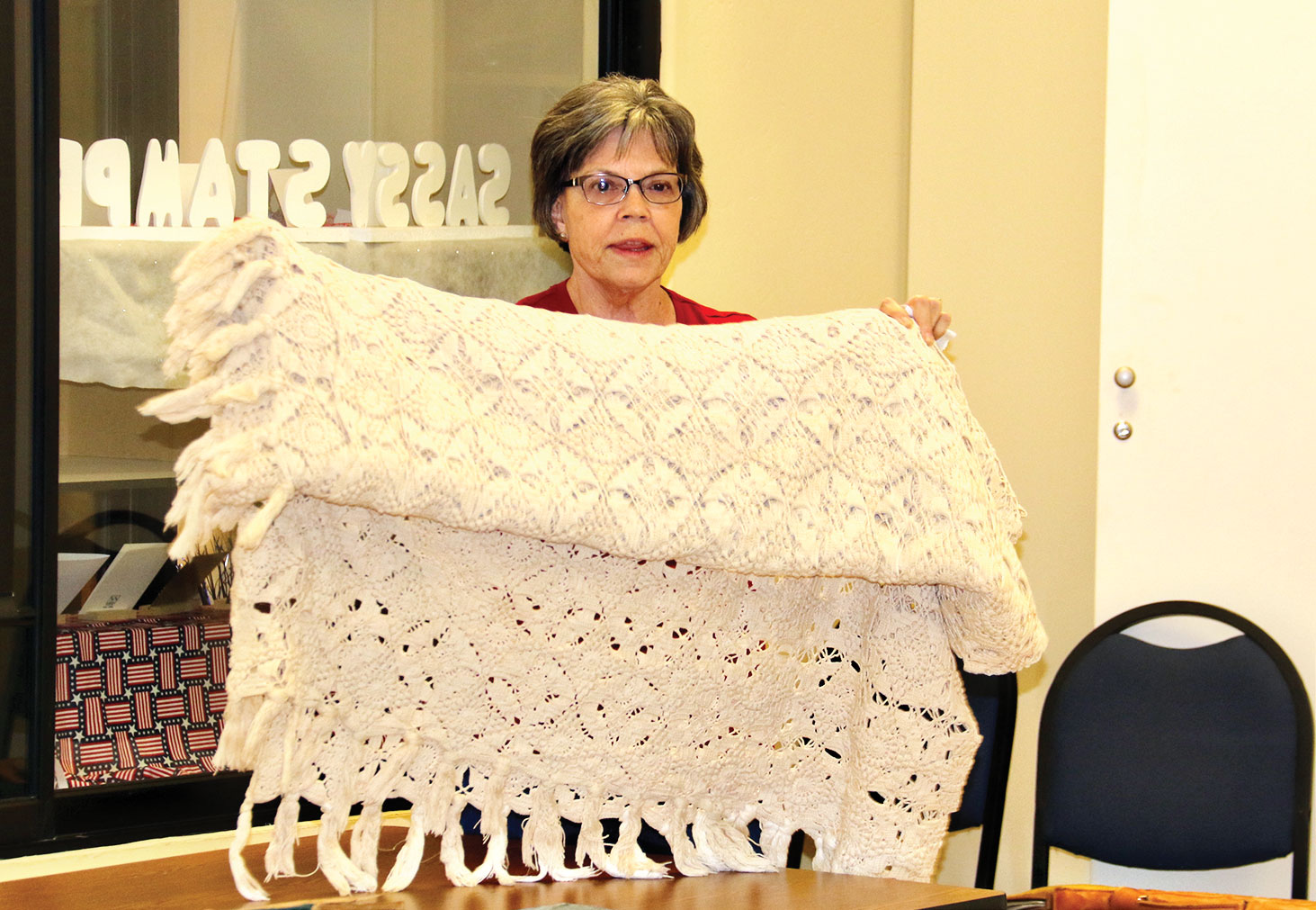 Karen Solomon showing handmade bedspread. Photo courtesy of Andy McConnell