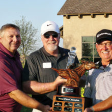 Jim McCracken, middle, is presented with the Championship Trophy by David Thatcher, the Club Head Professional, left, and Lawry Cohen, last year’s Club Champion on the right.