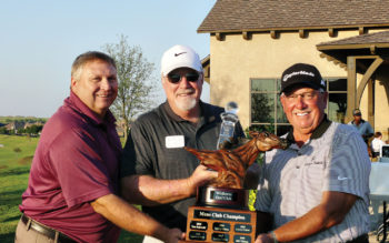 Jim McCracken, middle, is presented with the Championship Trophy by David Thatcher, the Club Head Professional, left, and Lawry Cohen, last year’s Club Champion on the right.
