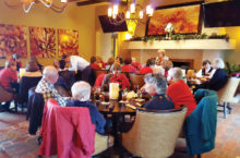 Library volunteers enjoy lunch and holiday decorations at the Wildhorse Grill.