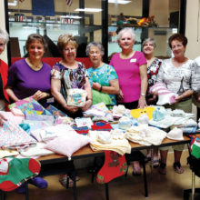 The volunteers for Operation Shower and some of the items they made.