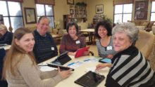 The iPad table had lots of customers. Was it because Santa delivered new iPads or was it that cute young librarian who knew everything about downloading digital materials? Rebecca Ivey, Denton librarian, Clyde Roberts, Barbara Roberts, Gloria Baer and Trudie Sammann