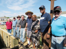 Kiwanis Club and happy homeowner showcasing the newly built ramp