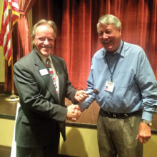 Russ Bafford receiving the gavel from outgoing president Don Kissock