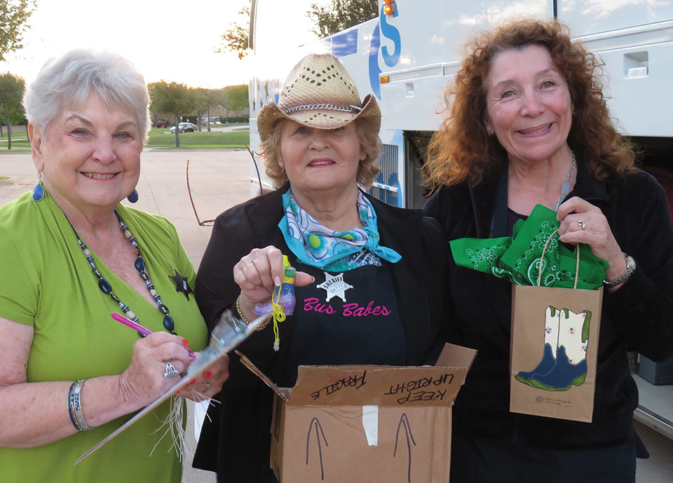 “Bus Babes” Jan Utzman, Betty Gardner and Judy Ondina loading the bus