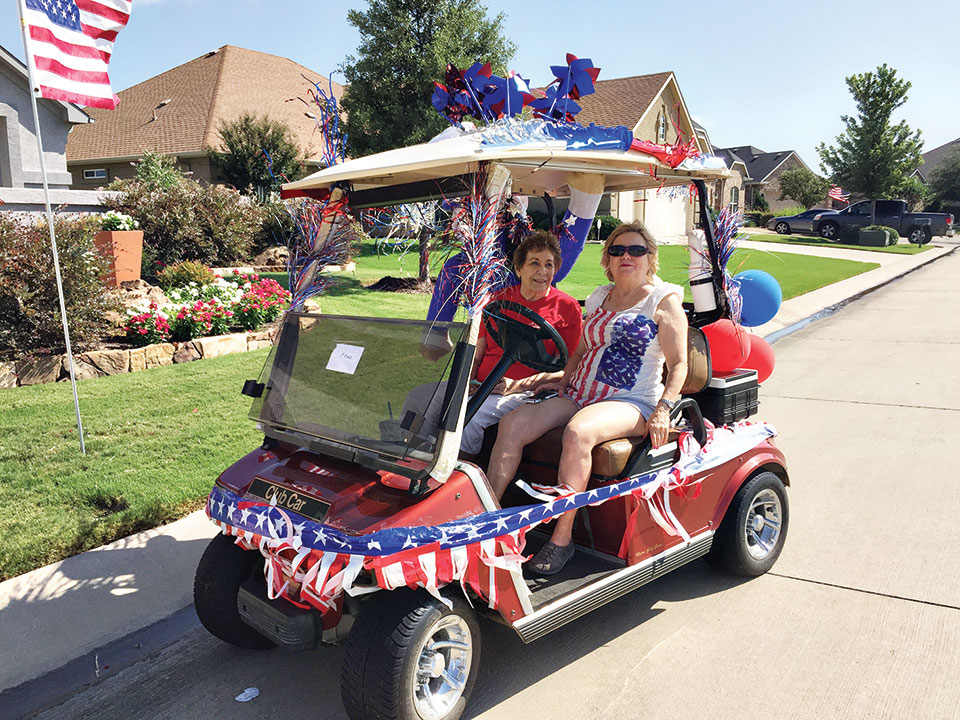 Joyce Sjerven and Tinka Levis of the Singles Club won first place for their patriotic cart decoration at the community Fourth of July parade.