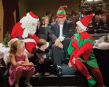 Choir  Director Dr. Arturo Ortega looks on as Santa visits Christmas at the Ranch 2016.