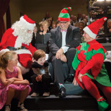 Choir  Director Dr. Arturo Ortega looks on as Santa visits Christmas at the Ranch 2016.