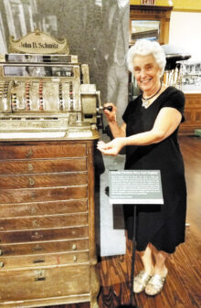 Bernadette Fideli is making change at the antique cash register.