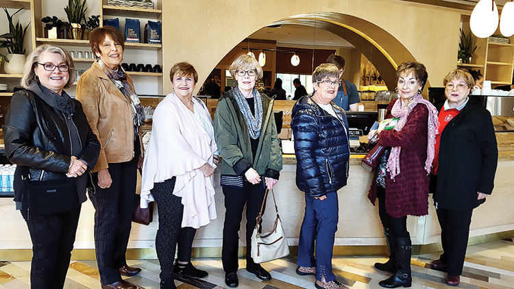 Ladies purchase coffee and muffins at the store entrance: (left to right) Diane Eoff, Nita Ice, Carol Cieslik, Rosemary Weinstein, Carol Cooley, Peggy Crandell, and Geraldine Gawle.