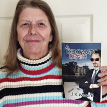 J.K. Moore with her book, A Diplomatic Death