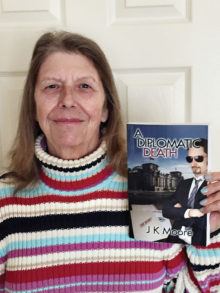J.K. Moore with her book, A Diplomatic Death