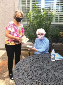 Medical conditions prevent Robson resident, Doris Lashlee, from visiting the library, so RR library board member, Sally Ryerson, regularly delivers books to her.