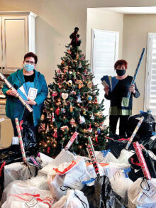 RRWC President Gayle Coe (left) and Community Relations Chair Nanci Odom with the gifts for Friends of the Family Adopt-a-Family program