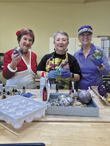 Elves Rosie, Anne, and Beverly display their dazzling creations.