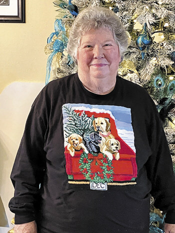 Judy Riffel, president of Paint & Palette, in front of her Peacock tree